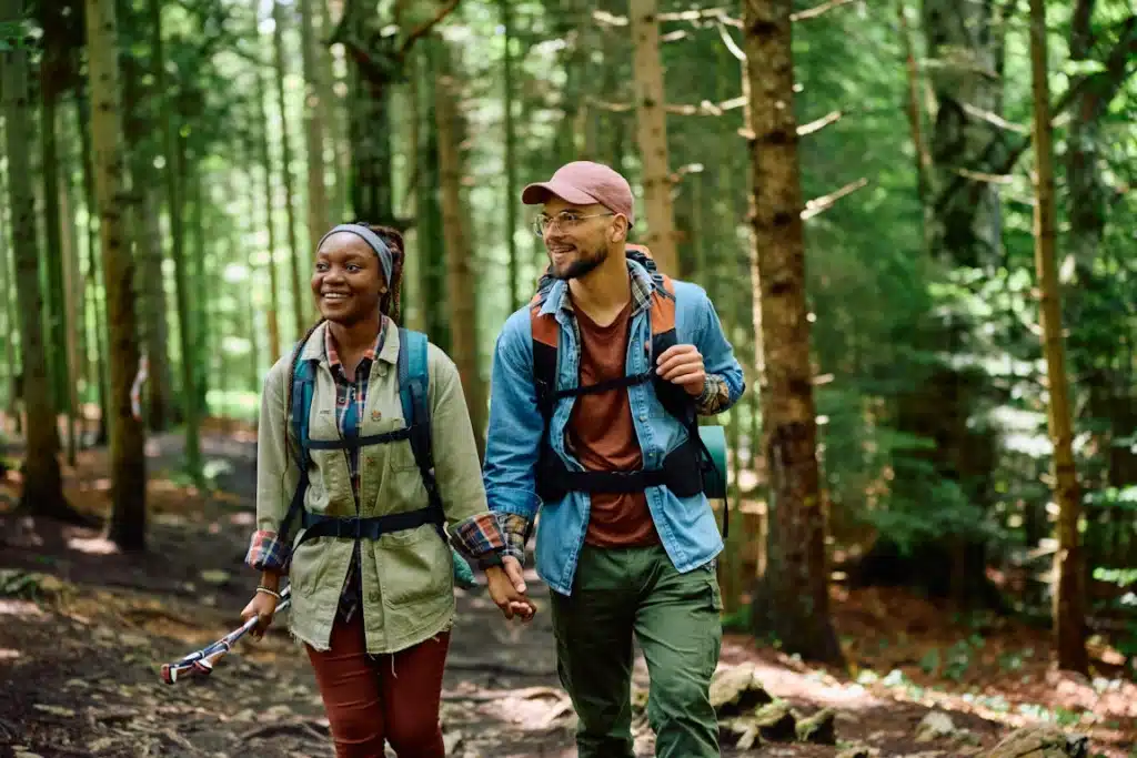 A happy couple hiking in the woods, free from depression thanks to TMS