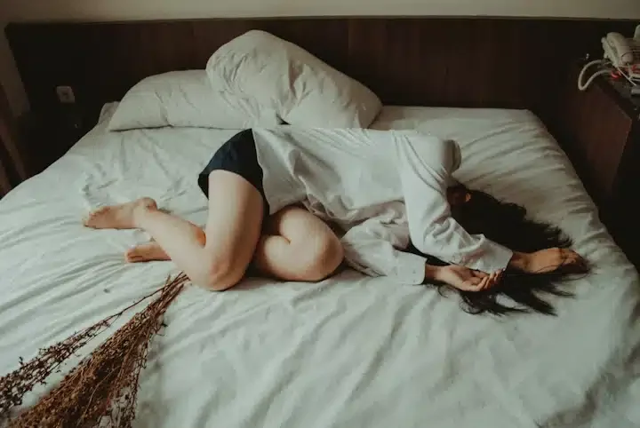 A woman struggles to get out of bed due to overwhelming depression