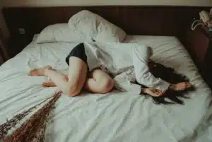 A woman struggles to get out of bed due to severe depression